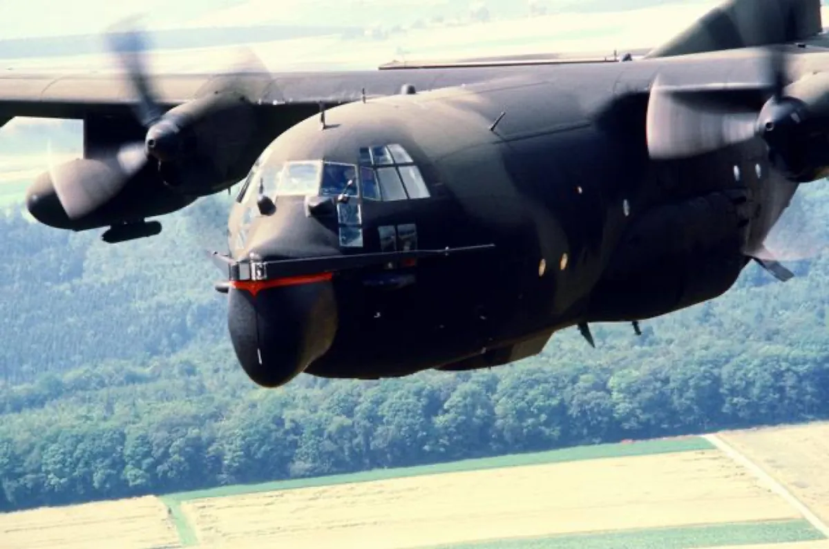 C-130 Hercules four-engine military transport in flight over farmland