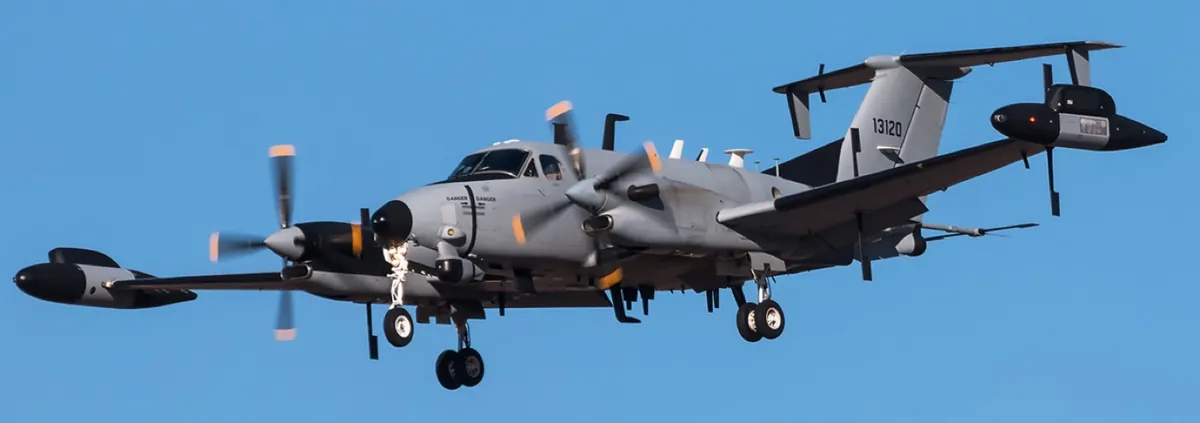 Twin-turboprop military surveillance aircraft with antenna arrays in flight