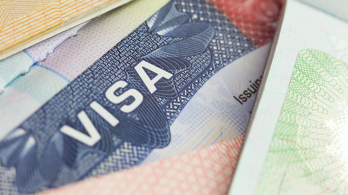 Close-up of a United States visa foil with the word VISA, tucked between passport pages